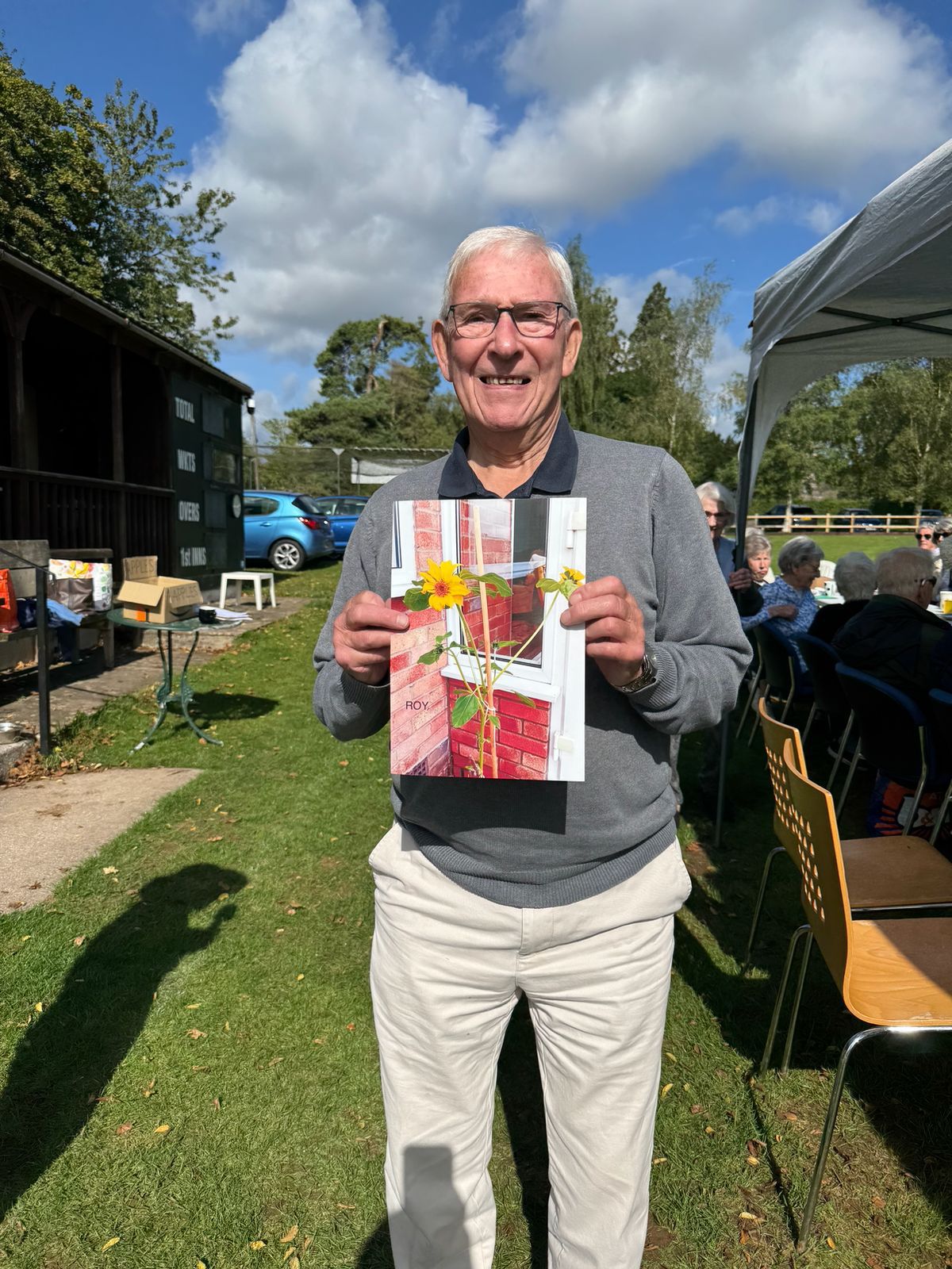 Roy proudly showing his sunflower photograph