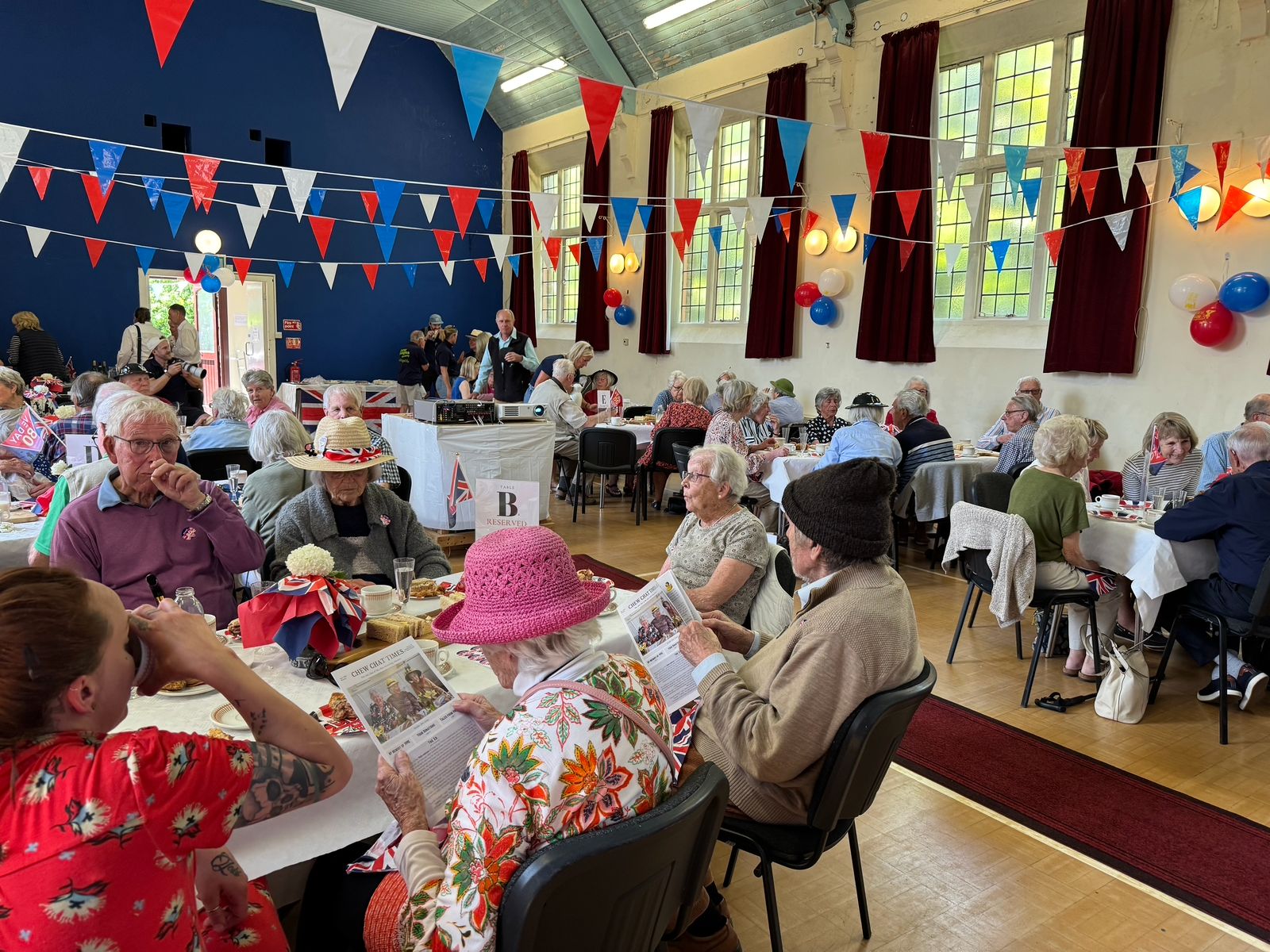 Chew Chatters enjoying a jubilee celebration in the community hall with bunting and balloons